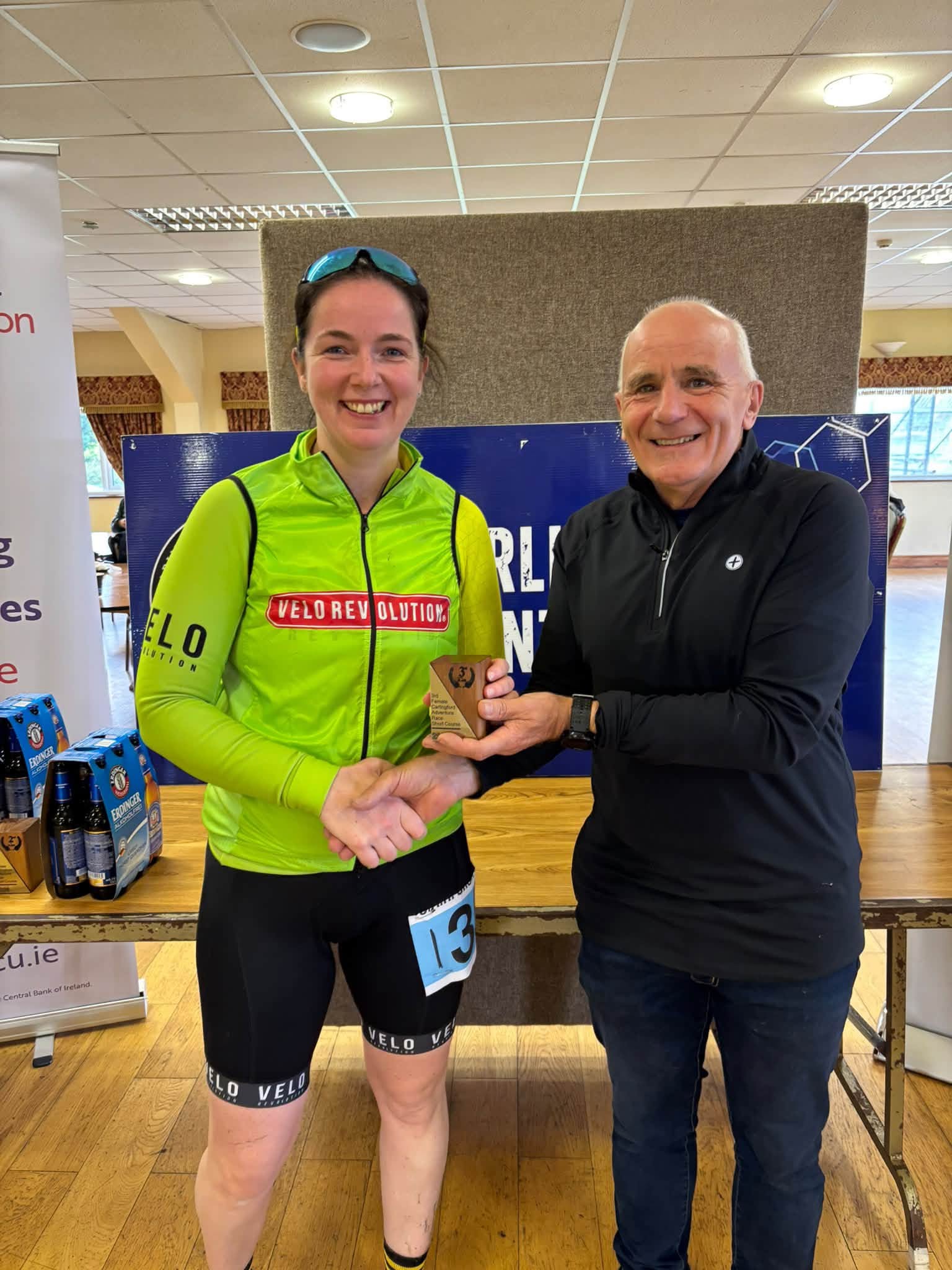 Prize giving: a winner in a green Velo Revolution cycling jersey is presented with a trophy